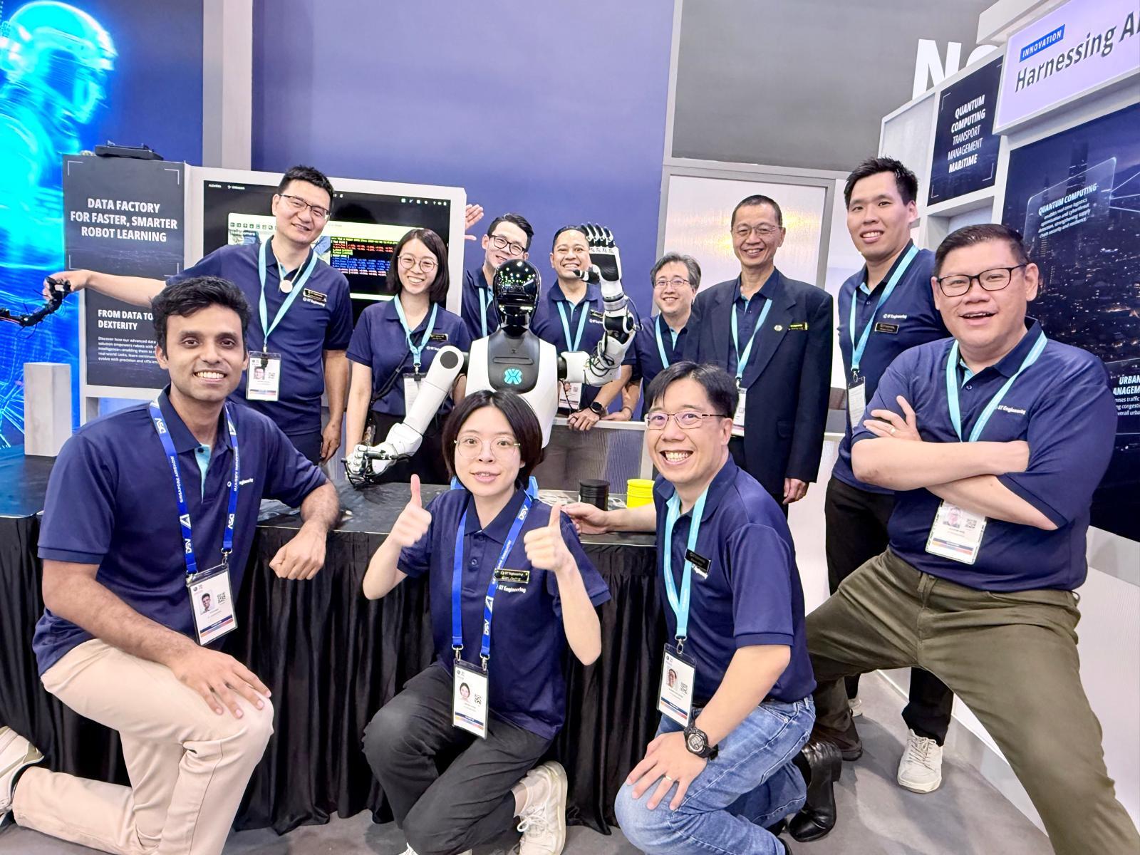 The ST Engineering team gathered around a humanoid robot at their exhibition booth, in front of a panel reading “From data to dexterity”